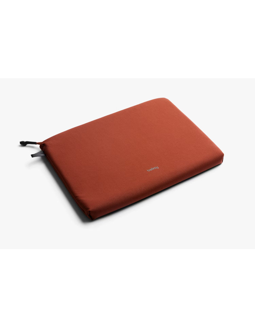 Bellroy Lite Laptop Sleeve 14 inch in clay color, slim protective case with smooth fabric exterior for MacBook or similar laptops.