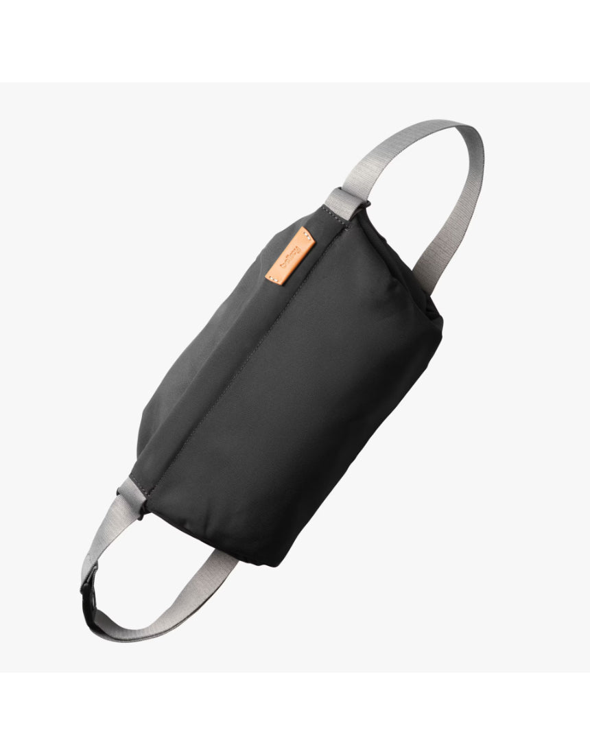 Bellroy sling bag in slate color with adjustable strap, compact design, and multiple pockets for everyday carry.