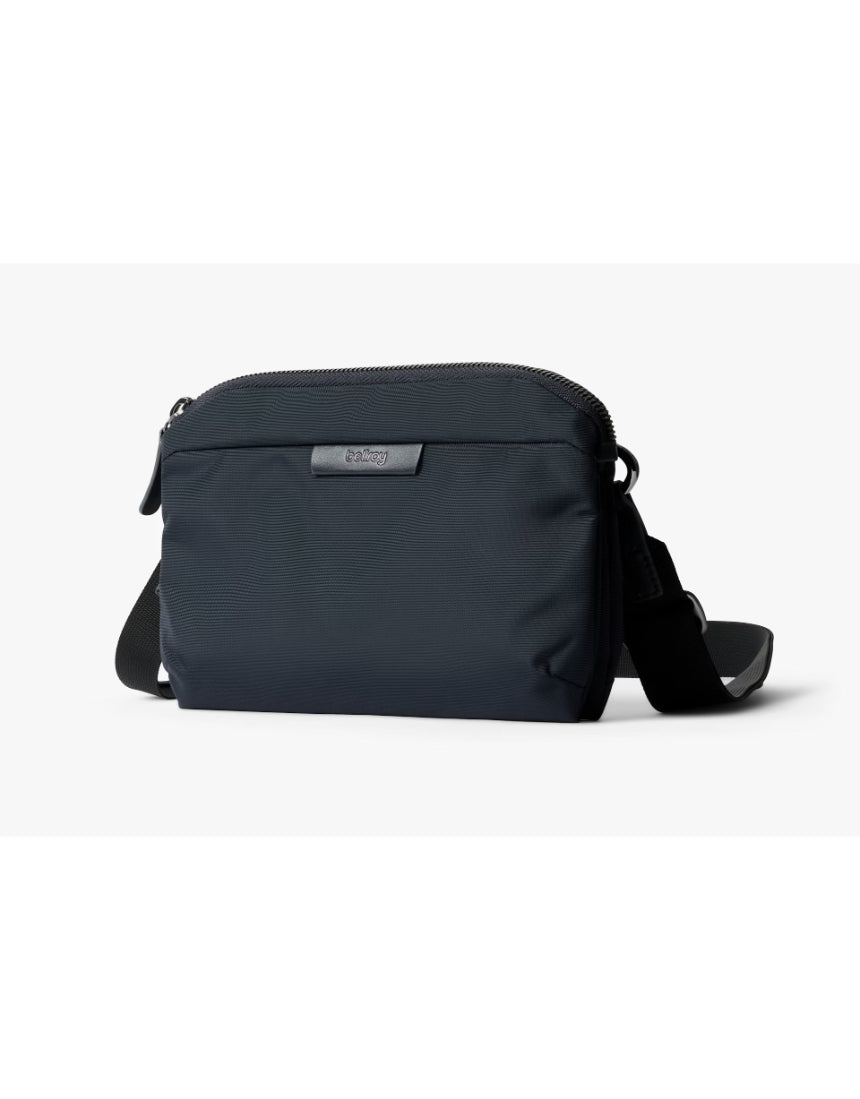 Bellroy Tokyo Side Bag in navy, a sleek crossbody bag with multiple compartments and adjustable strap, designed for everyday use.
