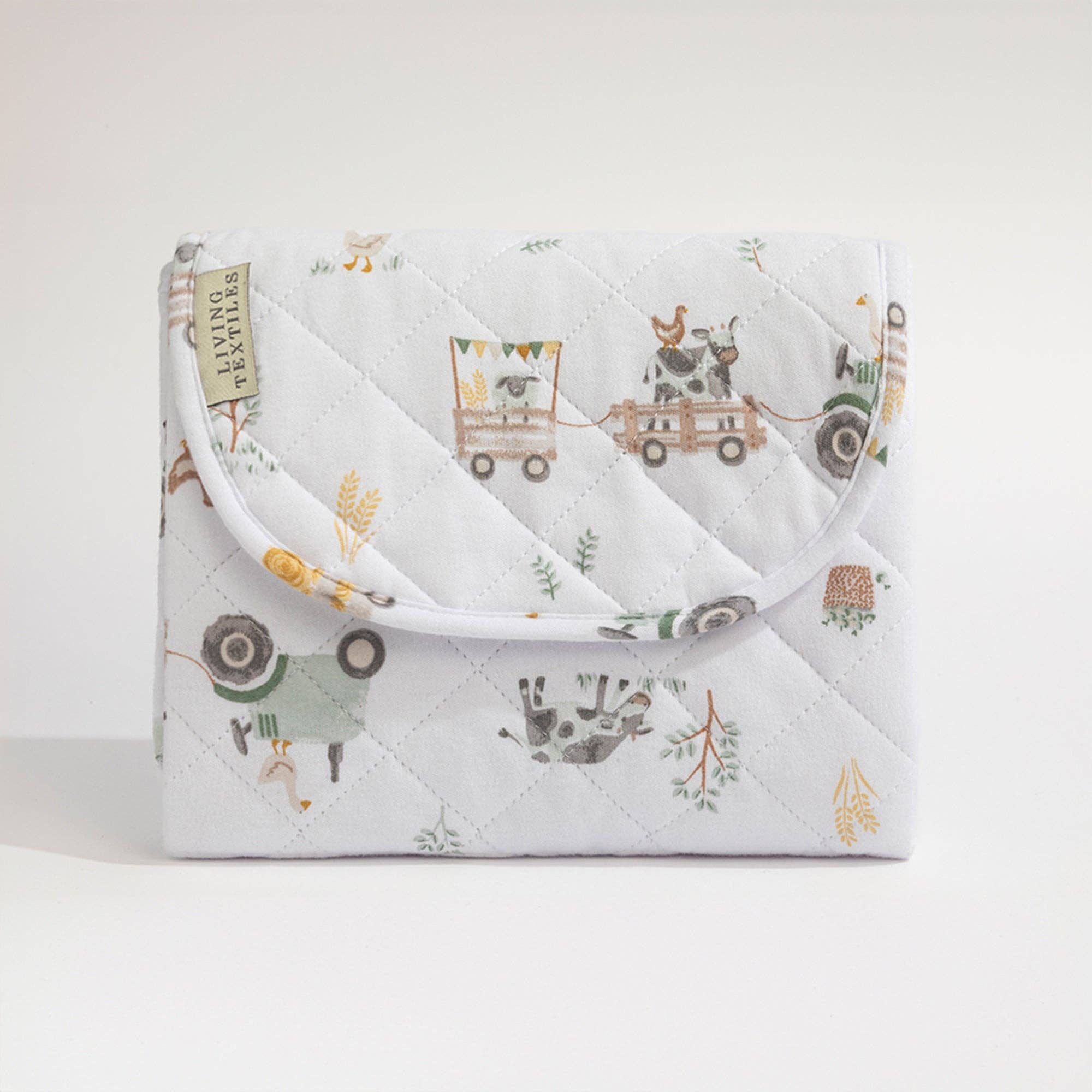 Living Textiles foldable waterproof travel change mat featuring tractor ride print, ideal for on-the-go diaper changes.