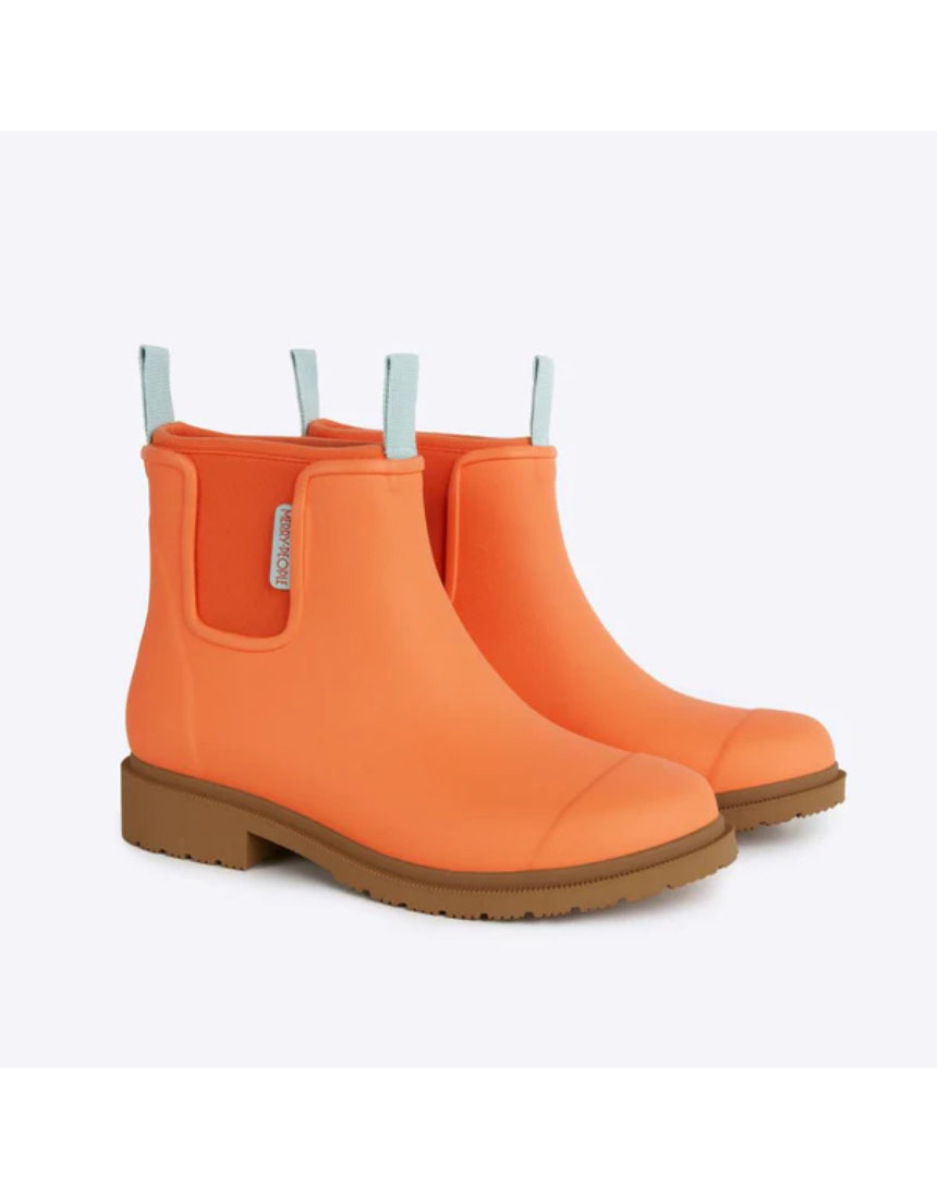 Merry People Bobbi gumboots in Sherbet Orange with a shiny rubber finish, shown from an angled view.