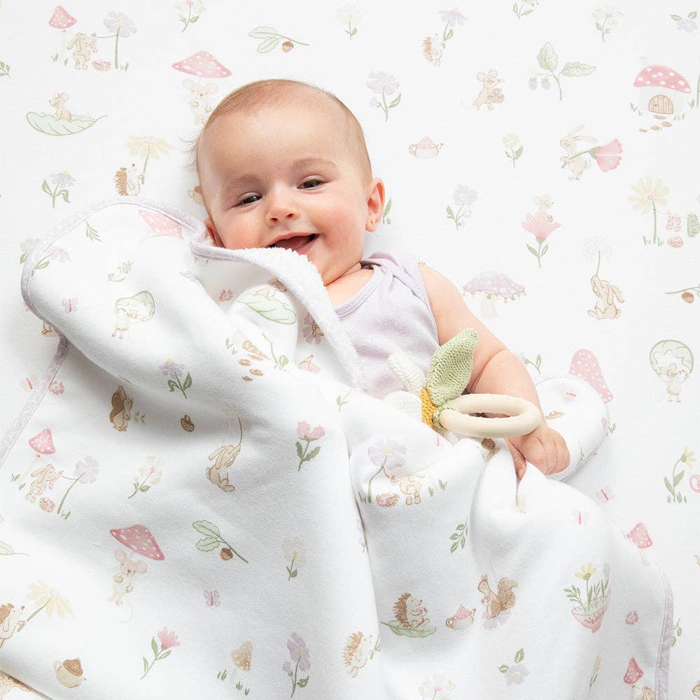 Living Textiles Jersey Sherpa Pram Blanket with whimsical Wonderland print, soft jersey fabric and cozy sherpa lining for babies.
