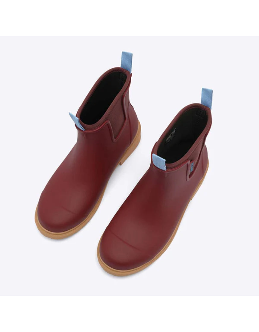 Brick red Merry People Bobbi gumboots shown from a high angle, featuring waterproof design and stylish rubber footwear for rainy days.