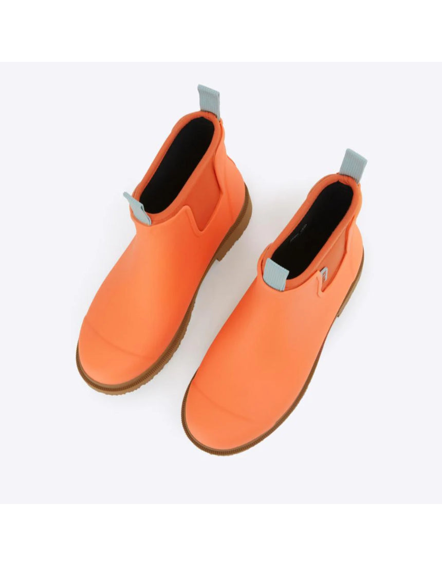 Merry People Bobbi gumboots in Sherbet Orange, high-angle view showing waterproof rubber footwear with textured sole.