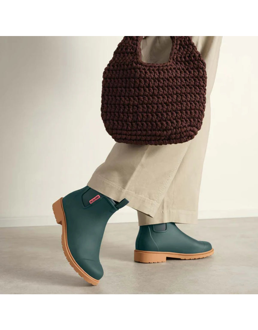 Merry People Bobbi Gumboots in teal worn by a model, featuring waterproof rubber design and stylish, vibrant teal color.