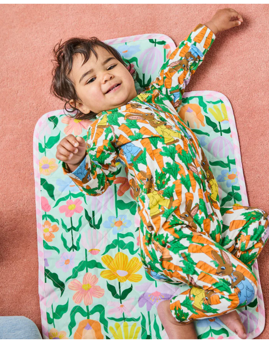 Kip & Co Popping Flowers Green baby change mat with colorful floral pattern, soft padded surface for comfortable diaper changes.