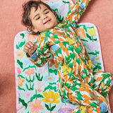 Kip & Co Popping Flowers Green baby change mat with colorful floral pattern, soft padded surface for comfortable diaper changes.
