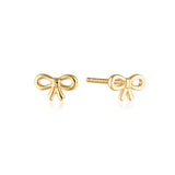 Linda Tahija bow stud earrings featuring gold-tone metal and small bow design, close-up view of the jewelry.
