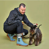 Seafoam Merry People Bobbi gumboots on a person outdoors, showcasing waterproof rubber footwear designed for rainy weather.