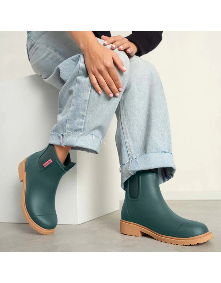 Merry People Bobbi Gumboots in teal worn by a model, stylish waterproof rubber boots for rainy weather.