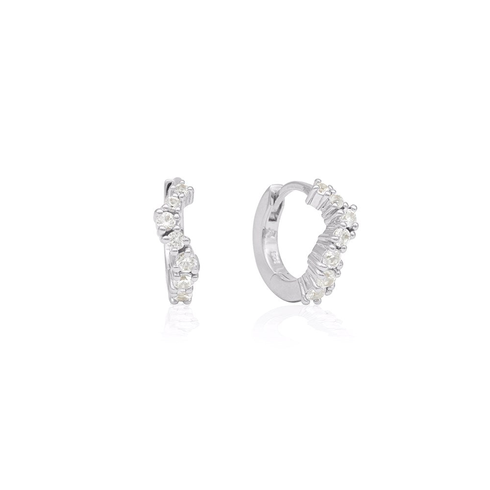 Linda Tahija Ebb Huggie earrings with lab-grown sapphire stones, featuring small, stylish gold hoops with sparkling blue sapphires.