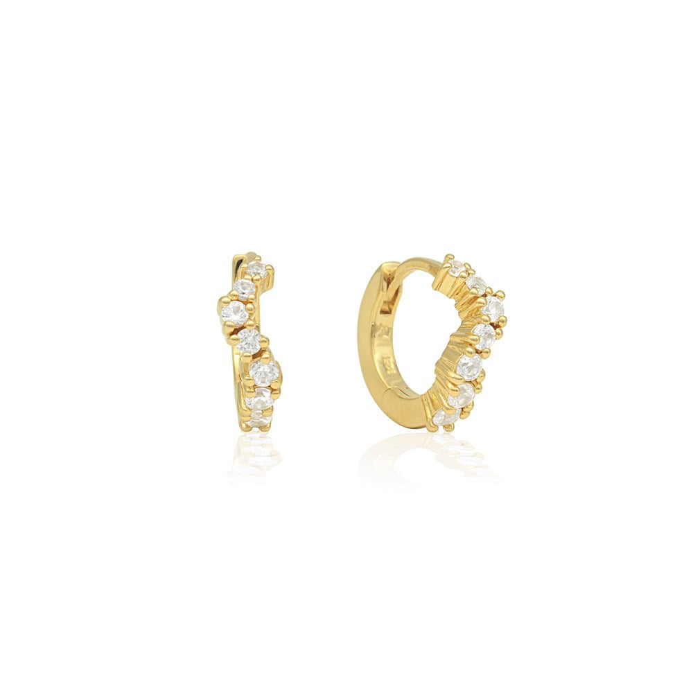 Linda Tahija Ebb Huggie earrings with lab-grown sapphire stones, featuring a sleek gold-tone design and secure hinge closure.