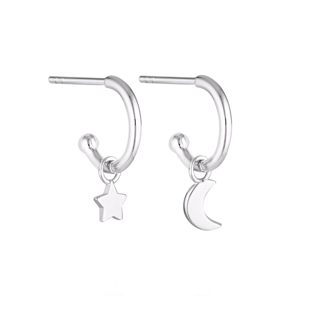 Linda Tahija star and moon charm earrings featuring delicate silver earrings with celestial-themed charms.