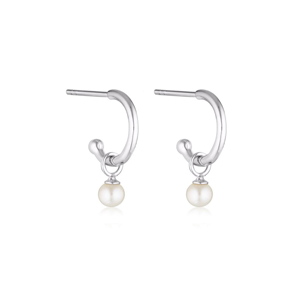 Linda Tahija Pearl Charm Hoop Earrings featuring gold hoops with dangling pearl charms and intricate detailing.