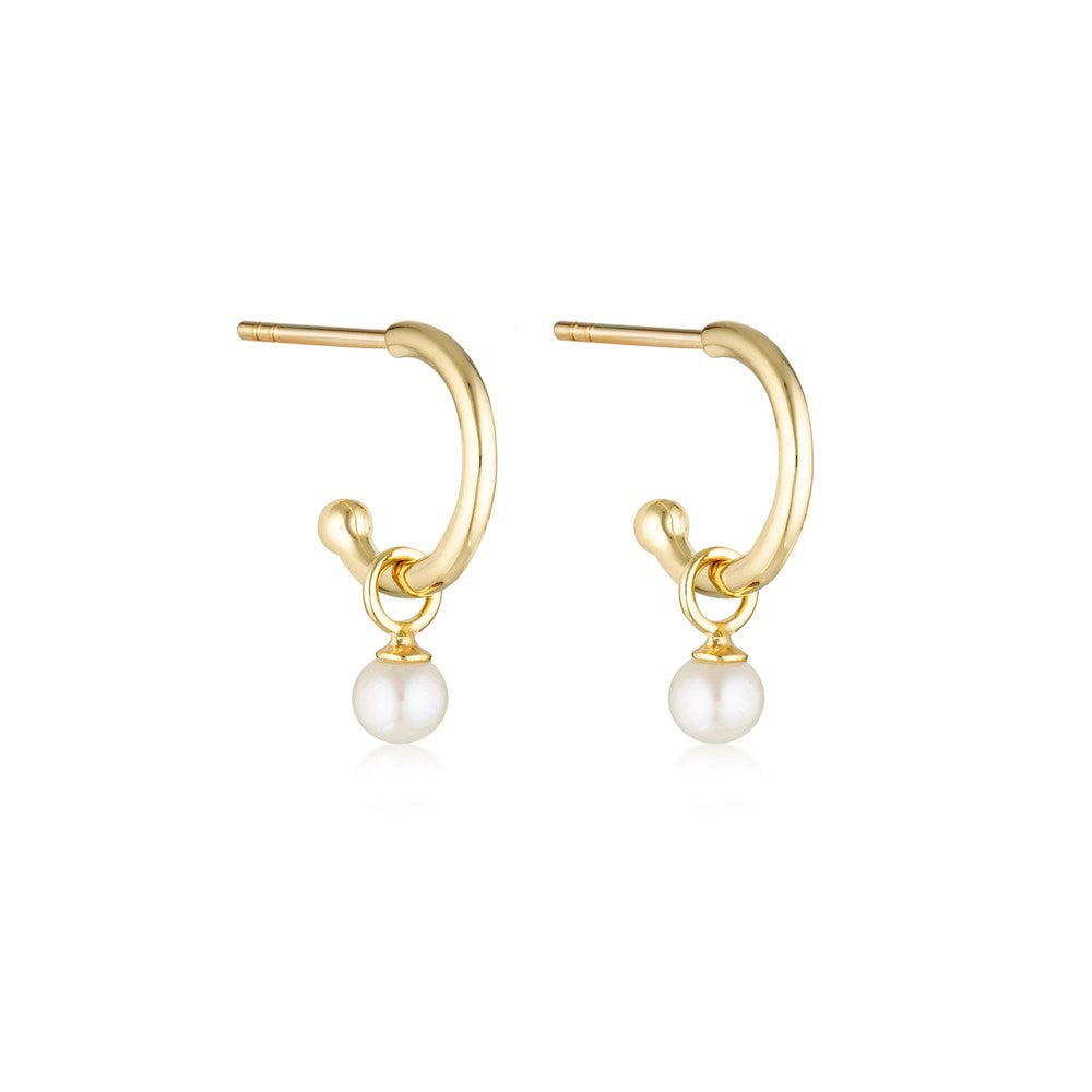 Linda Tahija pearl charm hoop earrings featuring gold base hoops with elegant pearl accents on a white background.