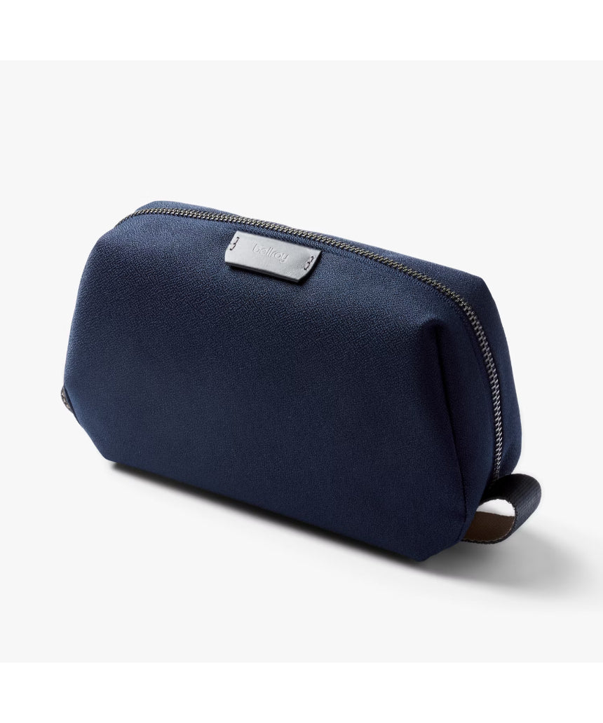 Bellroy Toiletry Kit in navy with zipper closure and multiple compartments for organizing personal grooming essentials.