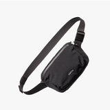 Bellroy Lite Belt Bag in black showing its compact design with adjustable strap and front pocket for everyday essentials.