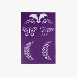 Reusable adhesive face paint stencil by Oh Flossy in purple, designed for creative face art and easy application.
