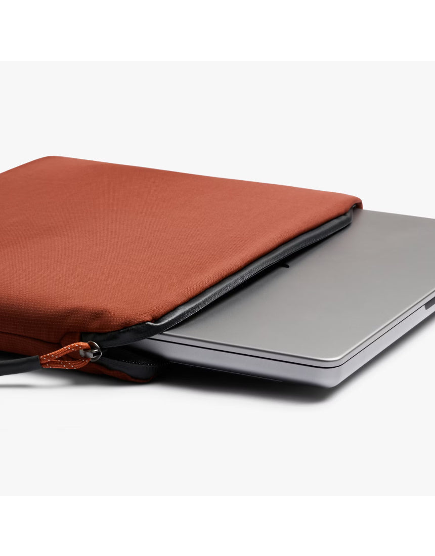Bellroy Lite Laptop Sleeve 14 inch in Clay showing the slim, protective interior with a laptop partially inserted.