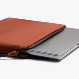 Bellroy Lite Laptop Sleeve 14 inch in Clay showing the slim, protective interior with a laptop partially inserted.