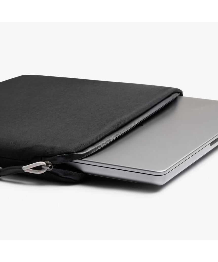 Black Bellroy Lite 16-inch laptop sleeve with smooth exterior and padded interior, designed for slim and secure laptop protection.