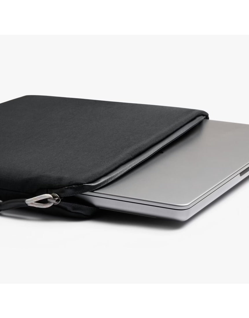 Black Bellroy Lite 16-inch laptop sleeve with smooth exterior and padded interior, designed for slim and secure laptop protection.