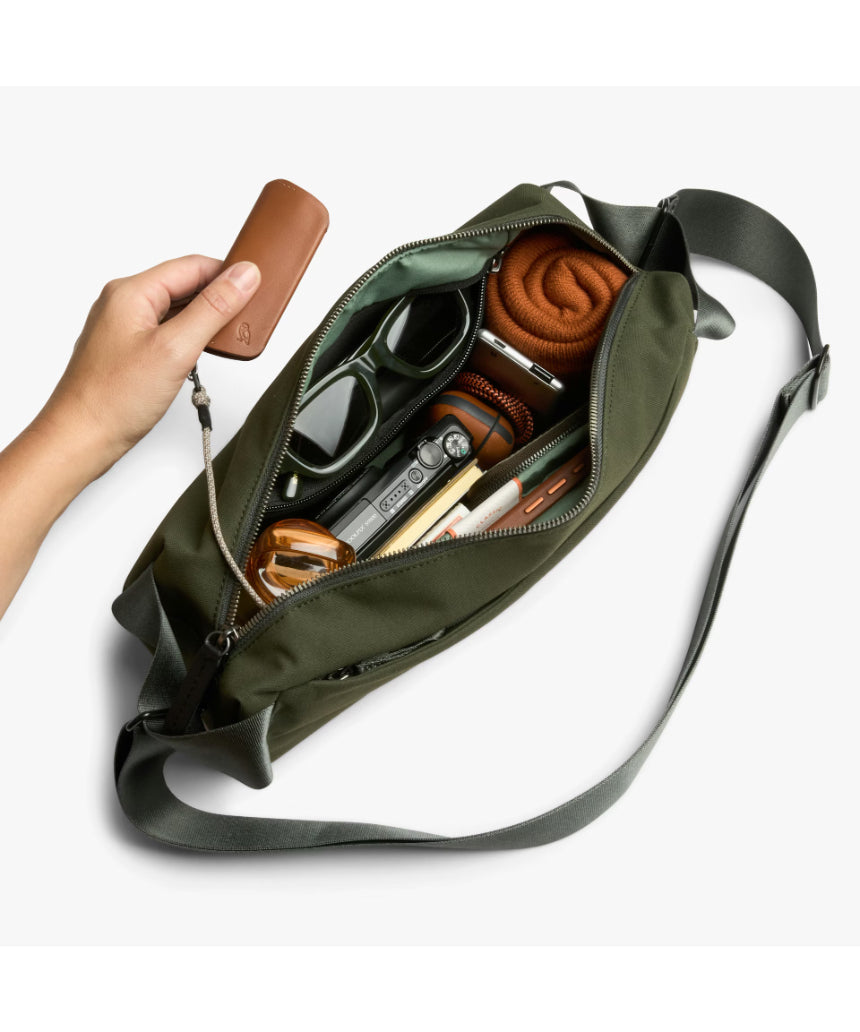 Bellroy Classic Sling bag in olive with adjustable strap and compact design, ideal for everyday carry and organization.