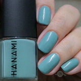 Hanami Cosmetics Still nail polish bottle with clear glass and black cap, showcasing the vibrant pink color inside.