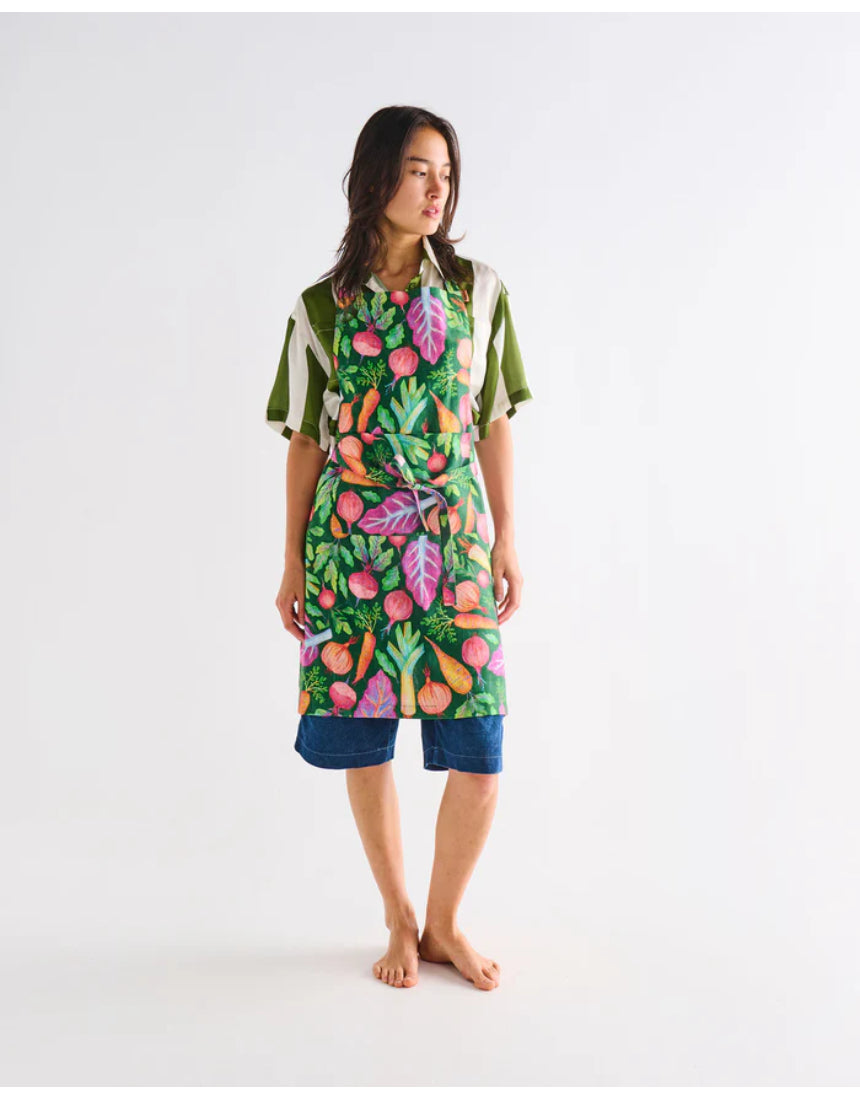Kip & Co veggie soup apron with colorful vegetable print, ties around the waist, designed for cooking and kitchen protection.