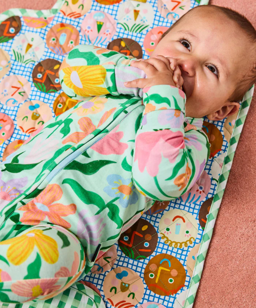 Kip & Co Cheer Up baby change mat with colorful, patterned fabric and padded surface for comfortable diaper changes.
