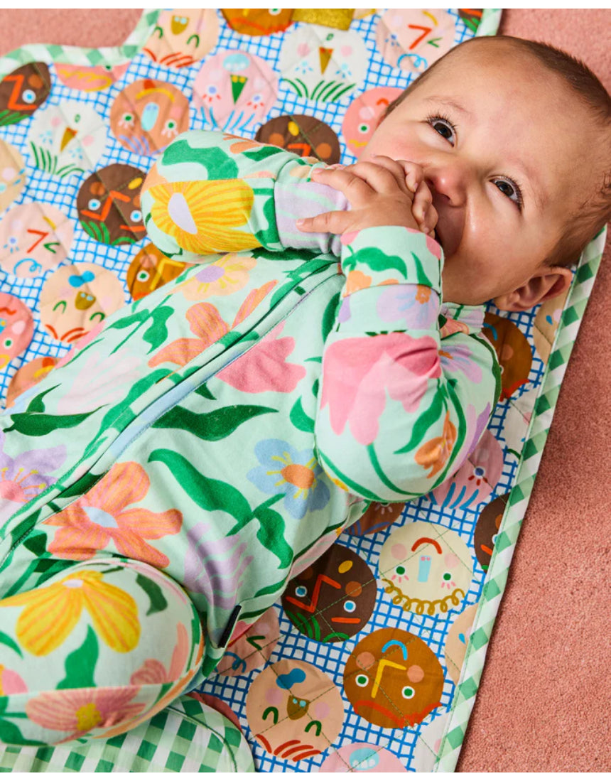 Kip & Co Cheer Up baby change mat with colorful, patterned fabric and padded surface for comfortable diaper changes.