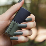 Hanami Cosmetics Hanami Moss nail polish bottle with greenish moss-colored nail polish on the brush