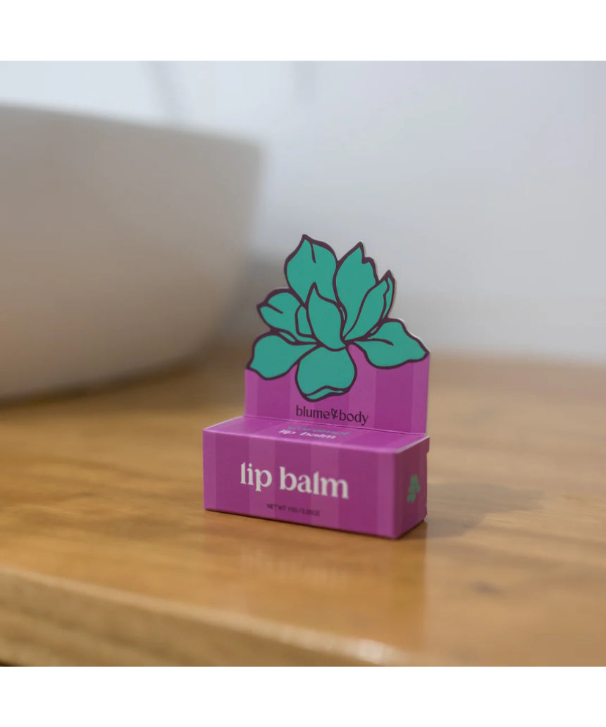 Bloom & Body caramel lip balm in a sleek tube, showcasing smooth, moisturizing balm with caramel scent and branding.