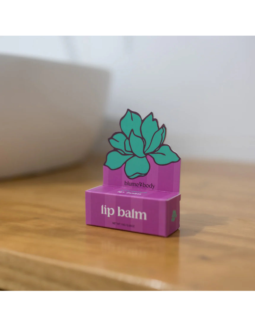 Bloom & Body caramel lip balm in a sleek tube, showcasing smooth, moisturizing balm with caramel scent and branding.