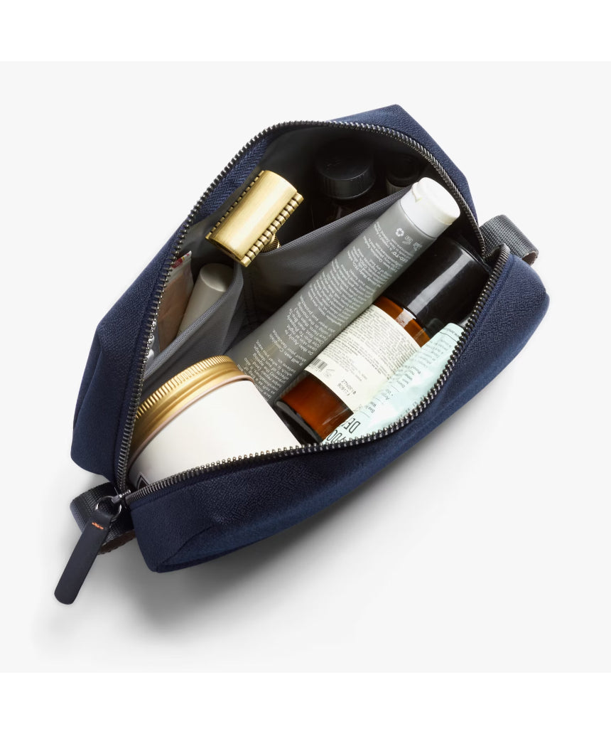 Bellroy Toiletry Kit in navy with zipper closure and compact design, ideal for travel storage of personal grooming essentials.