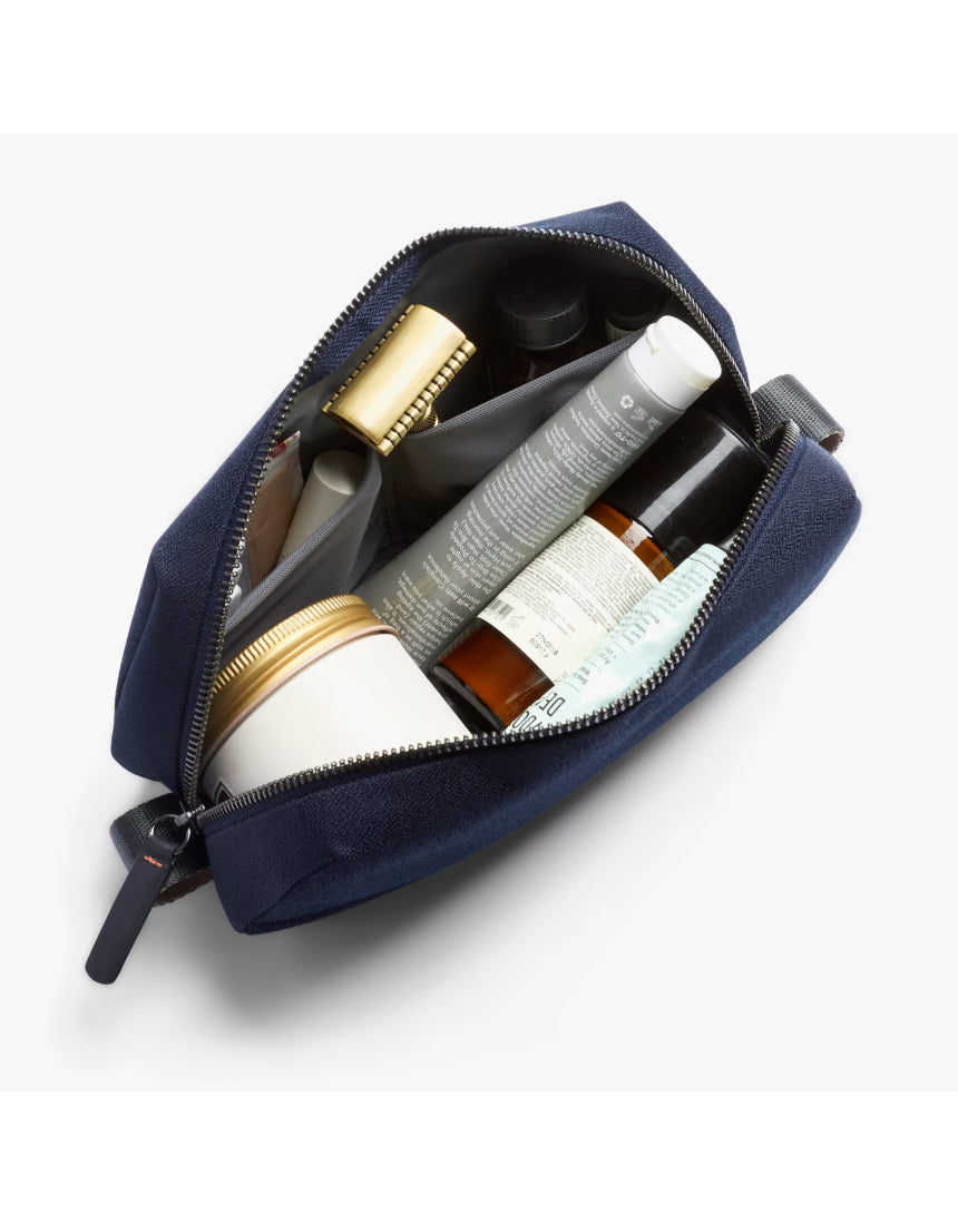 Bellroy Toiletry Kit in navy with zipper closure and compact design, ideal for travel storage of personal grooming essentials.