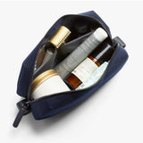 Bellroy Toiletry Kit in navy with zipper closure and compact design, ideal for travel storage of personal grooming essentials.