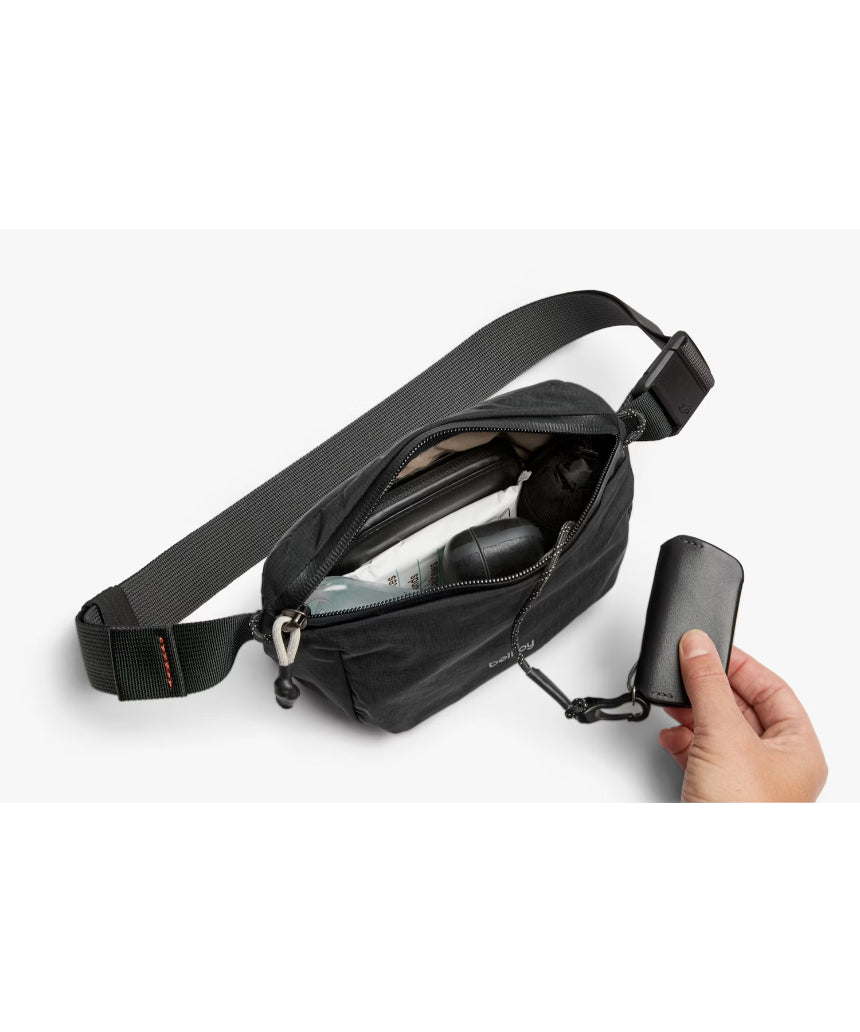 Bellroy Lite Belt Bag in black with adjustable strap and compact design, perfect for carrying essentials stylishly.