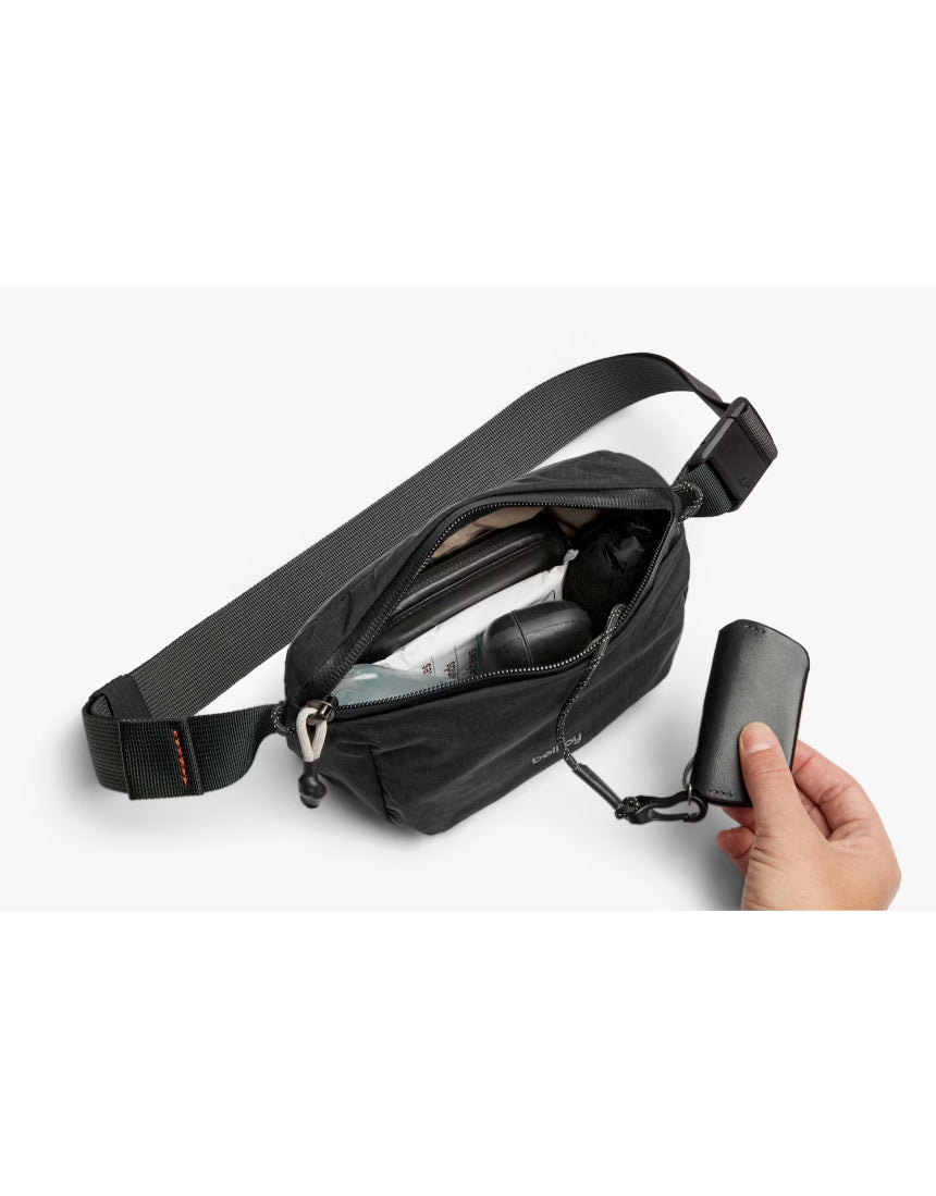 Bellroy Lite Belt Bag in black with adjustable strap and compact design, perfect for carrying essentials stylishly.