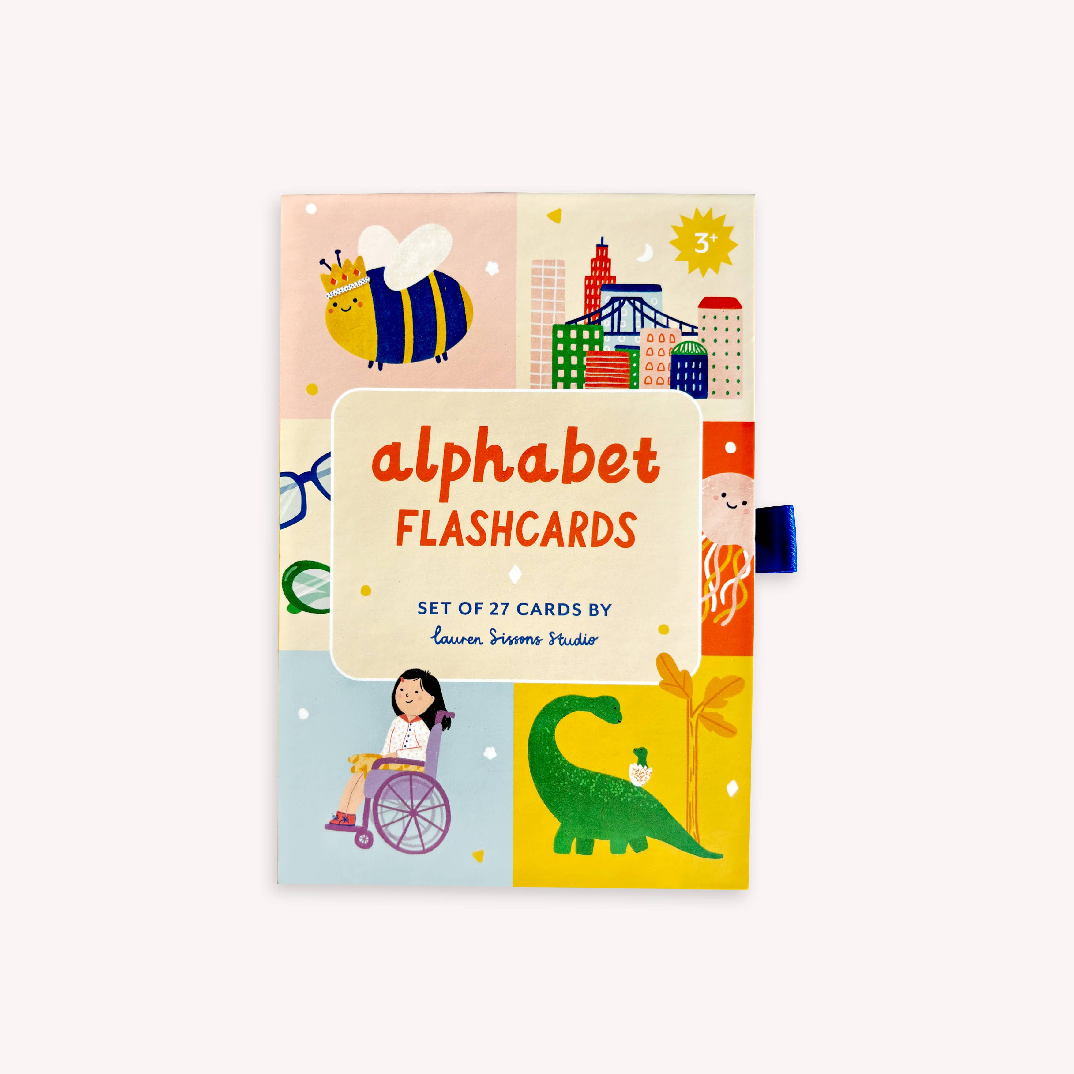 Lauren Sissons Studio A-Z illustrated alphabet flashcards laid out on a wooden surface with colorful letter illustrations.