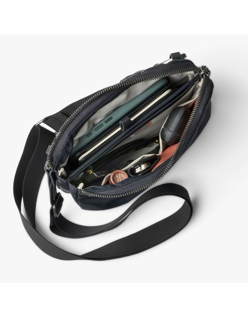 Bellroy Tokyo Side Bag crossbody bag in navy color, showing its sleek design and adjustable strap.