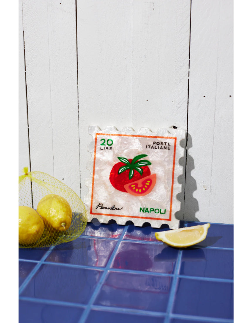 Jones & Co Pomodoro Stamp wall decor featuring a vintage-inspired red and white design on a wooden background.