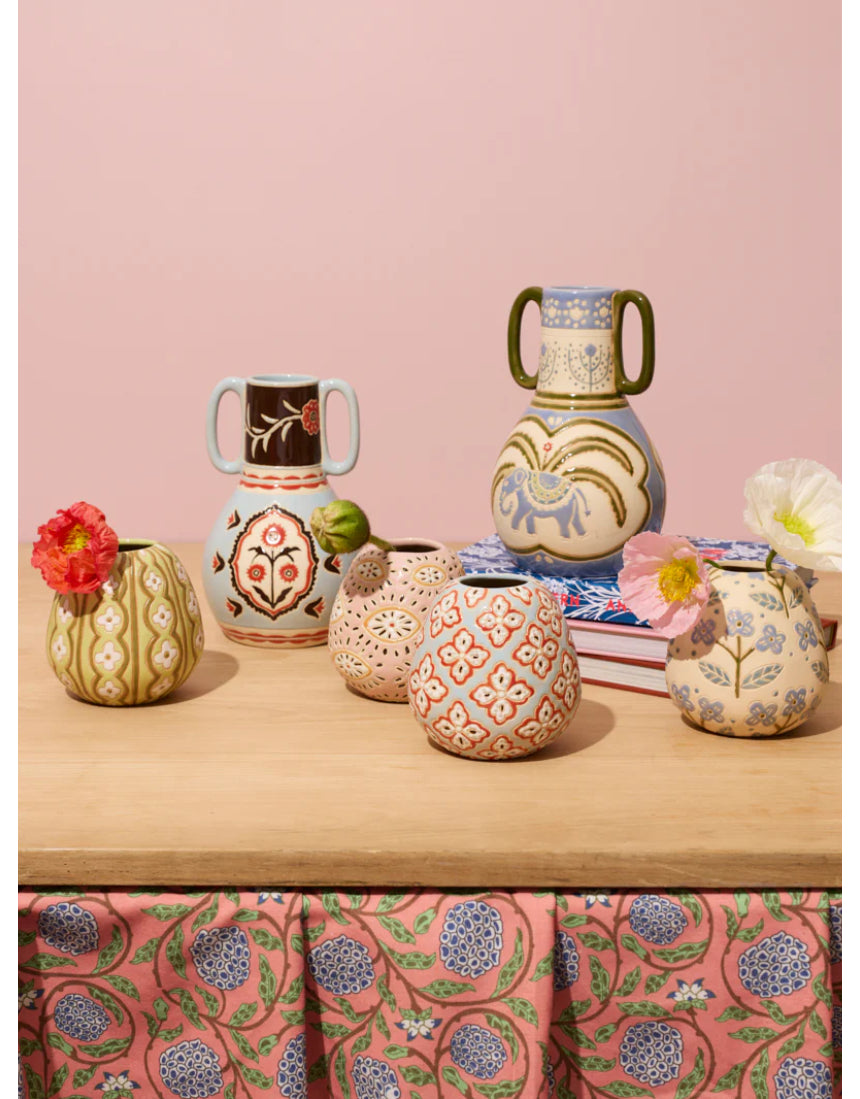 Jones & Co Samira vase filled with colorful flowers, showcasing a stylish decorative glass vase on a neutral background.