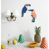 Jones & Co Canopy Toucan Peach wall art featuring a colorful toucan perched on branches with vibrant peach and green foliage.