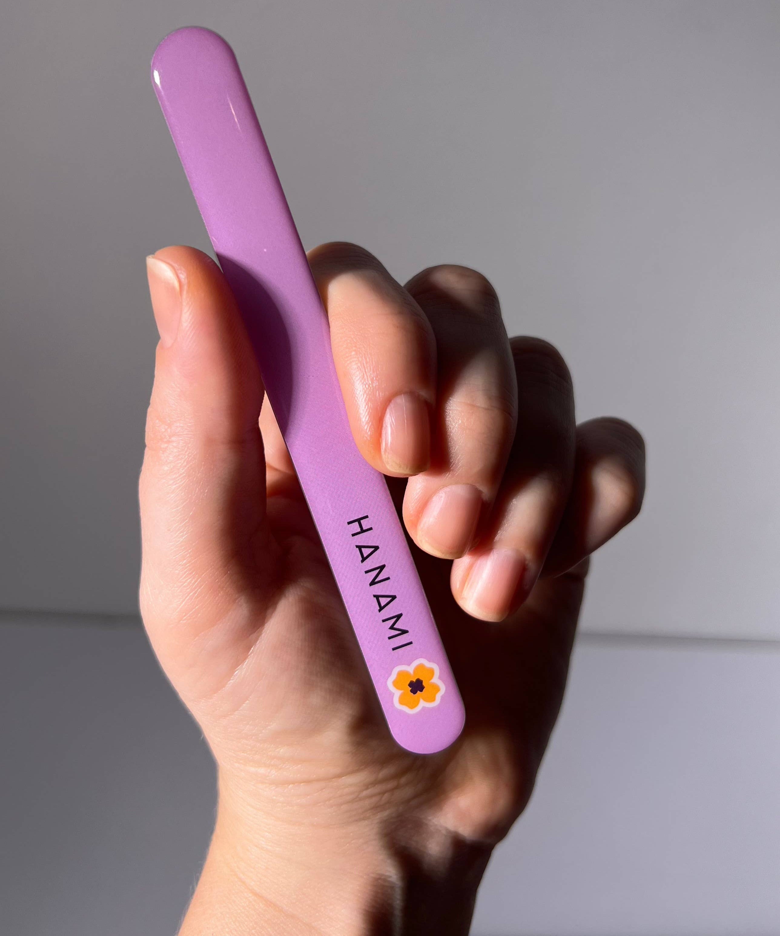 Hanami Nano Glass Nail File and Buffer from Hanami Cosmetics, showing the sleek, clear glass nail file on a white background.