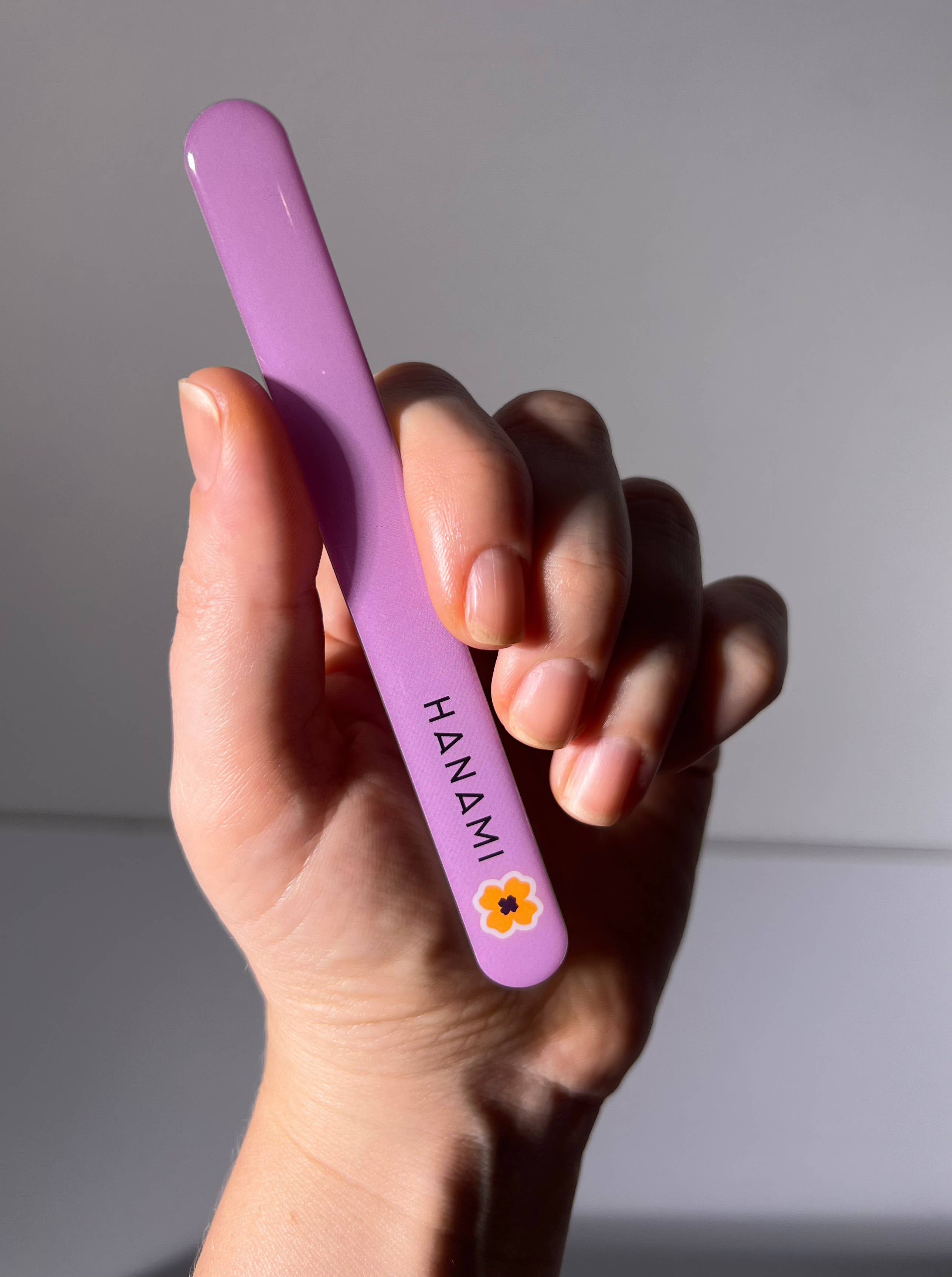 Hanami Nano Glass Nail File and Buffer from Hanami Cosmetics, showing the sleek, clear glass nail file on a white background.