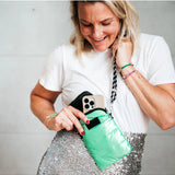 Say It Sister Amour phone pouch bag in salty safari print with adjustable strap and zip closure, stylish and compact accessory.