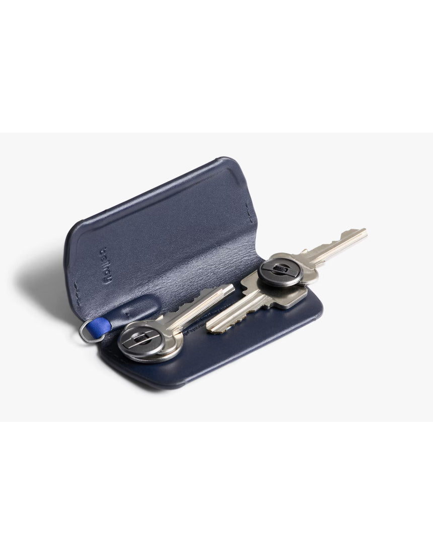 Bellroy Key Cover Plus 3rd Edition in navy with three key rings, compact leather key organizer on a white background.