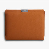 Bellroy 16-inch bronze laptop sleeve with padded interior and sleek design, featuring a smooth zipper and minimal aesthetic.