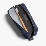 Bellroy navy toiletry kit with zipper and multiple compartments, designed for organized travel storage.